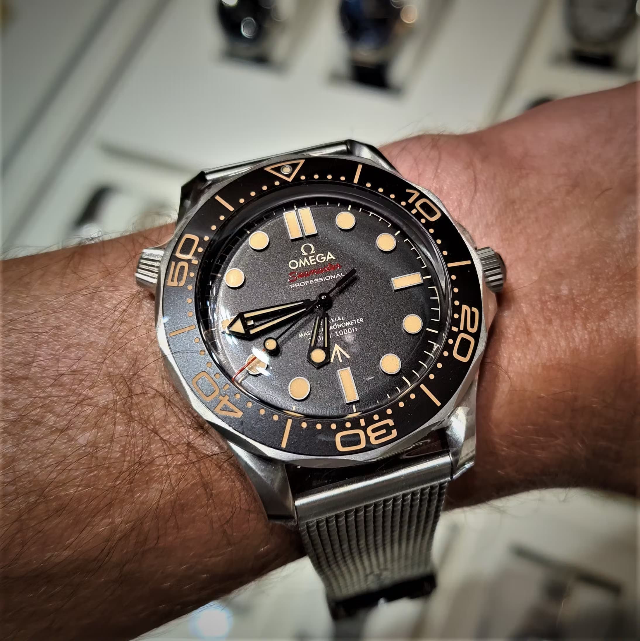 The Omega Seamaster Professional No Time to Die James Bond Watch. Note the tianium Milanese mesh bracelet.