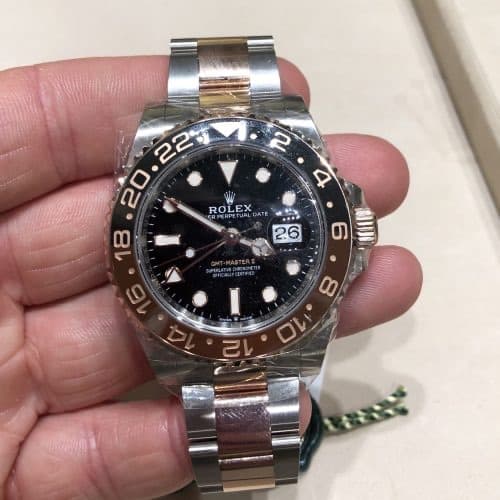 a steel Rolex GMT Master II Rootbeer 126711CHNR with red and blue bezel, black dial