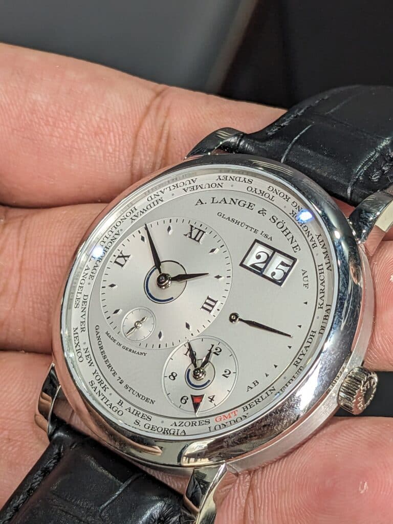 white gold lange und sohne lange 1 worldtimer with silver dial on a black strap